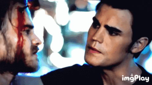 A Man With Blood On His Face Is Looking At Another Man GIF