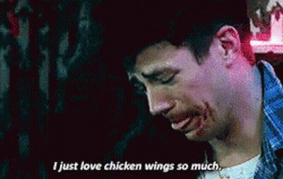 A Man With Blood On His Face Is Saying I Just Love Chicken Wings So Much . GIF