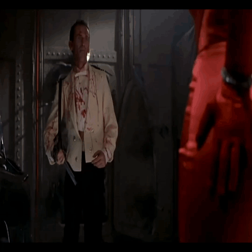 A Man With Blood On His Face Is Smiling And Looking At The Camera GIF