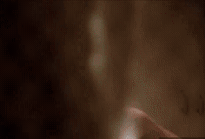 A Man With Blood On His Face Is Standing In A Locker Room . GIF