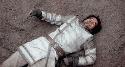 A Man With Blood On His Face Laying On The Ground GIF
