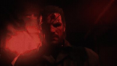 A Man With Blood On His Face Stands In A Dark Room GIF