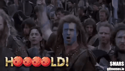 A Man With Blue And White Paint On His Face Screams In Front Of A Crowd And The Words Hooooold GIF