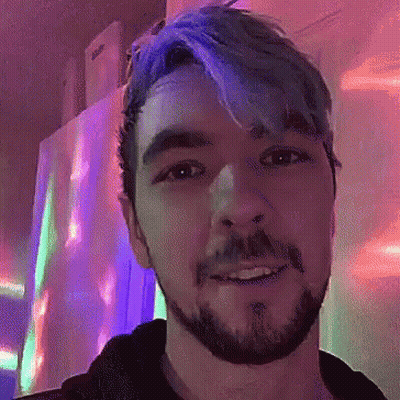 A Man With Blue Hair And A Beard Smiles GIF