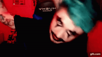 A Man With Blue Hair Is Wearing A Black Shirt That Says Yh2uh On It . GIF