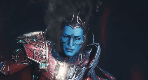 A Man With Blue Paint On His Face And Glasses GIF