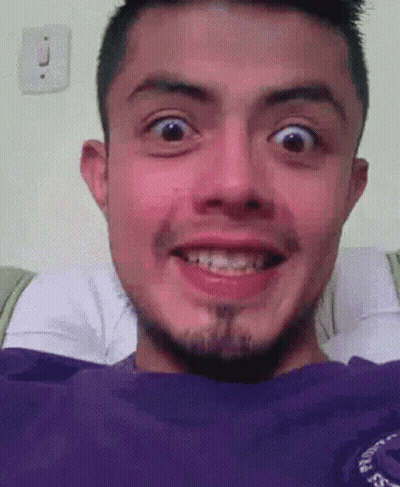 A Man With Braces On His Teeth Is Smiling With His Mouth Open GIF