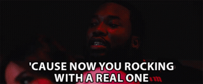 A Man With Braces On His Teeth Says " Cause Now You Rocking With A Real One " In A Dark Room GIF