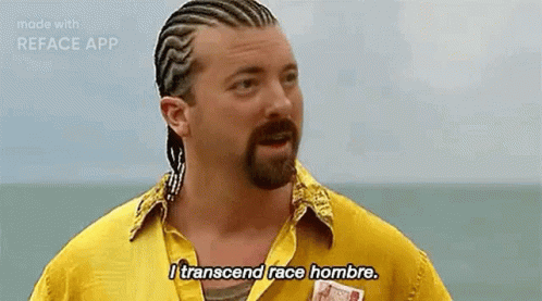 A Man With Braids And A Beard Is Wearing A Yellow Shirt And Says `` I Transcend Race Hombre . '' GIF