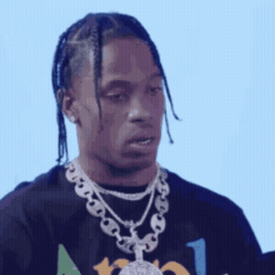 A Man With Braids Is Wearing A Black Shirt And A Silver Chain Around His Neck . GIF