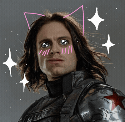 A Man With Cat Ears Drawn On His Face Looks At The Camera GIF