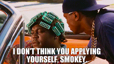 A Man With Curlers On His Hair Is Talking To Another Man In A Car . GIF