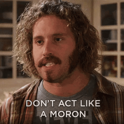 A Man With Curly Hair And A Beard Is Saying " Don 'T Act Like A Moron " GIF