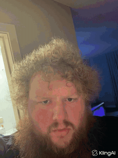A Man With Curly Hair And A Beard Is Taking A Selfie With Klingai In The Corner GIF
