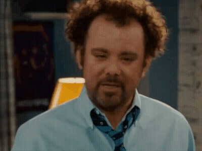 A Man With Curly Hair And A Beard Is Wearing A Blue Shirt And A Blue Tie . GIF