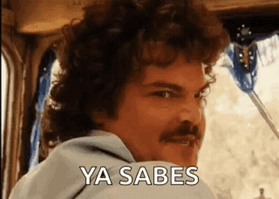 A Man With Curly Hair And A Mustache Is Sitting In A Car And Saying Ya Sabes . GIF
