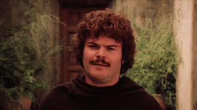 A Man With Curly Hair And A Mustache Is Wearing A Black Sweater GIF