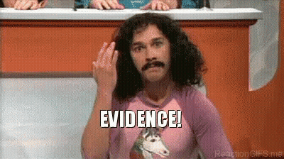 A Man With Curly Hair And A Mustache Is Wearing A Pink Shirt With A Unicorn On It And Says Evidence ! GIF