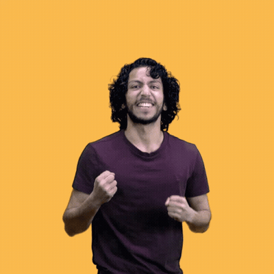 A Man With Curly Hair And A Purple Shirt Is Raising His Arms In The Air GIF