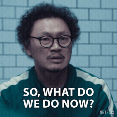 A Man With Curly Hair And Glasses Is Asking " So What Do We Do Now " GIF