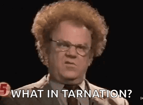 A Man With Curly Hair And Glasses Is Asking What In Tarnation ? GIF