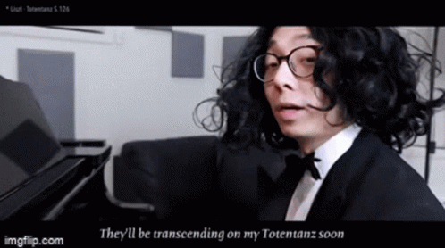 A Man With Curly Hair And Glasses Is Playing A Piano And Says They 'Ll Be Transcending On My Totetanz Soon GIF