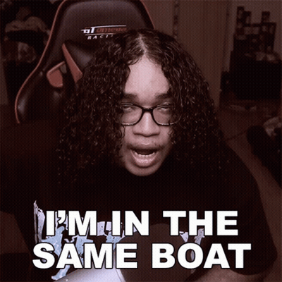 A Man With Curly Hair And Glasses Says " I 'M In The Same Boat " While Sitting In A Gaming Chair GIF