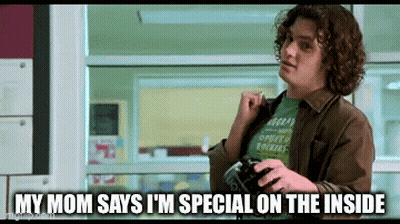 A Man With Curly Hair Is Holding A Camera And Says " My Mom Says I 'M Special On The Inside " . GIF
