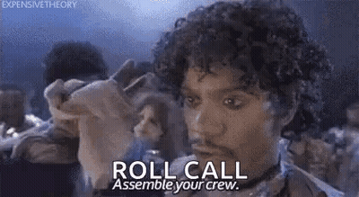 A Man With Curly Hair Is Holding A Piece Of Paper And Says `` Roll Call Assemble Your Crew . '' GIF