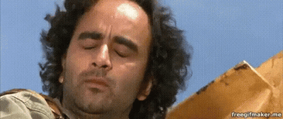 A Man With Curly Hair Is Looking Down With His Eyes Closed And His Mouth Open . GIF