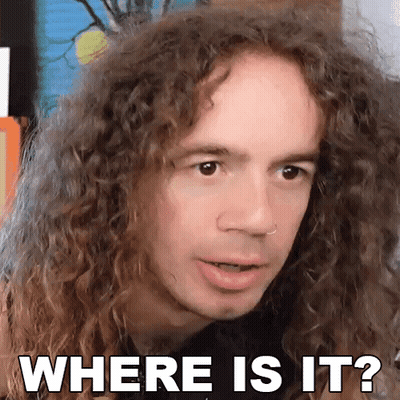 A Man With Curly Hair Is Making A Face And Asking Where Is It GIF