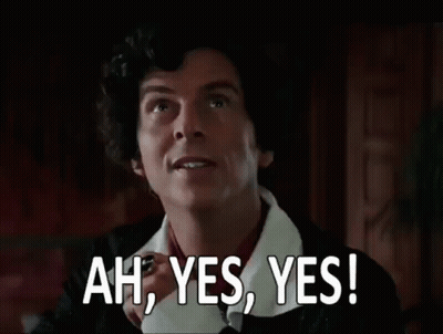 A Man With Curly Hair Is Making A Funny Face And Saying `` Ah , Yes , Yes ! '' GIF