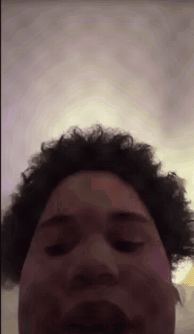 A Man With Curly Hair Is Making A Funny Face GIF