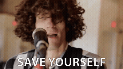 A Man With Curly Hair Is Singing Into A Microphone With The Words `` Save Yourself '' Written Below Him . GIF