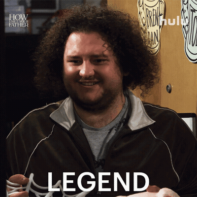 A Man With Curly Hair Is Smiling And Holding A Hot Dog In Front Of A Sign That Says " How I Met Your Father " GIF
