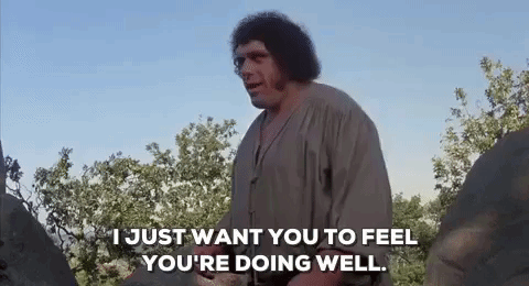 A Man With Curly Hair Is Standing In A Field Talking To Another Man While Holding A Sword . GIF