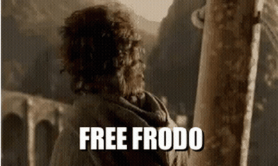 A Man With Curly Hair Is Standing Next To A Pole With The Words `` Free Frodo '' On It . GIF