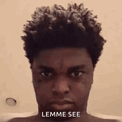 A Man With Curly Hair Is Taking A Selfie In A Bathtub . GIF