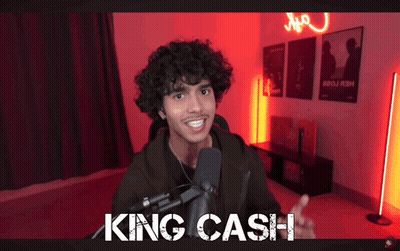 A Man With Curly Hair Is Talking Into A Microphone With The Words King Cash Written On The Bottom GIF