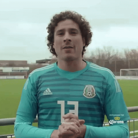 A Man With Curly Hair Is Wearing A Green Adidas Jersey With The Number 13 On It GIF