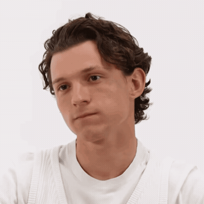 A Man With Curly Hair Is Wearing A White Sweater GIF