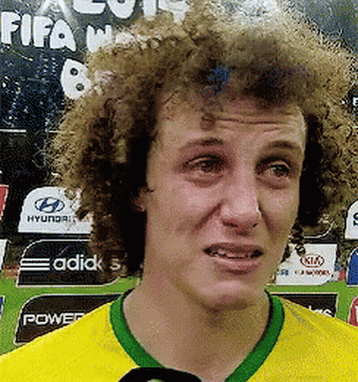 A Man With Curly Hair Is Wearing A Yellow And Green Shirt With A Green Collar GIF