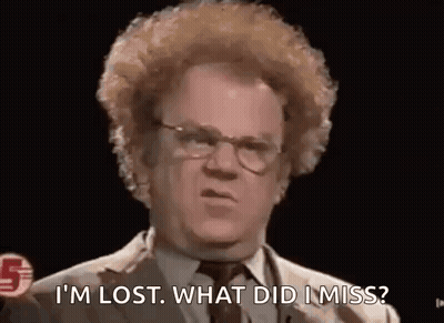 A Man With Curly Hair Is Wearing Glasses And A Suit And Tie . GIF