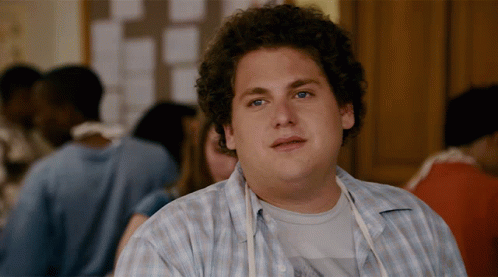 A Man With Curly Hair Wearing A Blue Plaid Shirt GIF