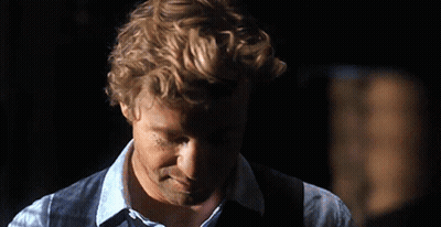 A Man With Curly Hair Wearing A Blue Shirt And Vest GIF