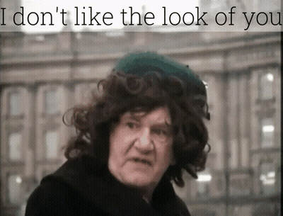 A Man With Curly Hair Wearing A Green Hat With The Words I Don 'T Like The Look Of You Above Him GIF