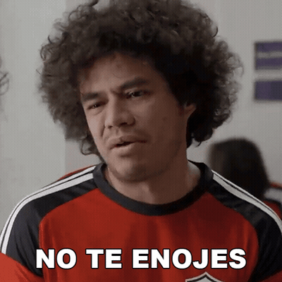 A Man With Curly Hair Wearing A Red Shirt That Says " No Te Enojes " GIF