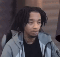 A Man With Dreadlocks And A Beard Is Sitting In A Chair With His Eyes Closed . GIF