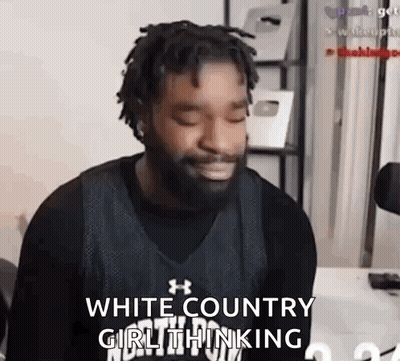 A Man With Dreadlocks And A Beard Is Sitting In Front Of A Microphone And Making A Face . GIF