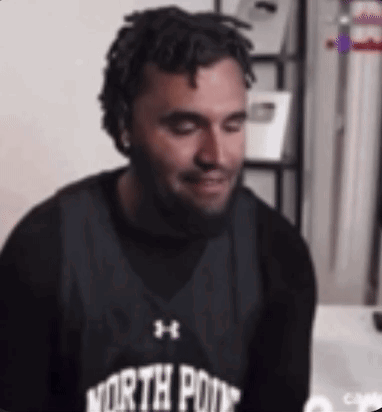 A Man With Dreadlocks And A Beard Wearing A North Point Basketball Jersey . GIF